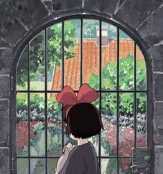 a girl looking out an open window at flowers