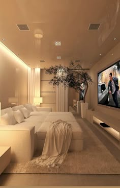 a large living room with white furniture and a flat screen tv mounted on the wall