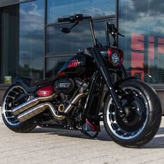 a black and red motorcycle parked in front of a building