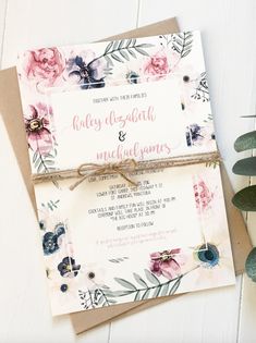 the wedding card is tied up with a string and flowers are on top of it