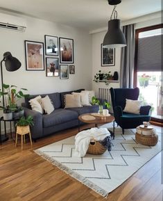 a living room filled with furniture and pictures on the wall above it's windows