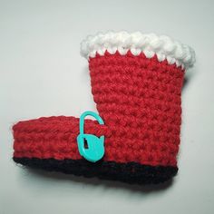 there is a crocheted red and black boot with a blue hook on it