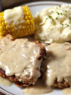 meatloaf with gravy, mashed potatoes and corn on the cob