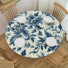 the table is set with two plates and four chairs, which are decorated with blue flowers