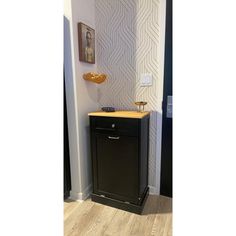 a small black cabinet in the corner of a room