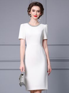 Escalating your style with timeless sophistication, this mother of the bride dress is designed to make a lasting impression. The dress boasts a crisp white color, offering a fresh and elegant look that is perfect for weddings and other special occasions. The neckline is delicately embellished with sparkling details, providing a subtle hint of glamour. Short sleeves offer a comfortable and modest fit, making it suitable for all-day wear. The dress features a tailored silhouette that flatters the figure, creating a sleek and polished appearance. Made from high-quality materials, this dress ensures comfort and longevity, allowing you to enjoy the event without any discomfort. The simplicity of the design allows for versatility in accessorizing, making it easy to pair with statement jewelry an Elegant White A-line Dress, Elegant Knee-length Mother Of The Bride Dress, Elegant A-line Mother Of The Bride Dress, Elegant White Evening Midi Dress, Elegant White Midi Dress For Evening, White A-line Fitted Mother Of The Bride Dress, Elegant Midi-length Mother Of The Bride Dress, Elegant Midi Dress For Banquet, White Sheath Midi Dress For Banquet