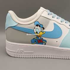 Elevate your sneaker game with the Nike Air Force 1 Character Duck Blue Custom. This one-of-a-kind shoe features a unique duck blue colorway and custom detailing for a truly stand-out look. With the iconic Air Force 1 design and Nike's top-notch quality, these sneakers are sure to provide both style and comfort. Step up your street style with these statement kicks. ★ Brand new with box ★ Each pair is unique and one of a kind ★ Each pair is personally handmade, painted with high quality Angelus. Blue Casual Custom Sneakers, Customizable Blue Sneakers For Streetwear, Custom Blue Sneakers, Custom Blue Low-top Sneakers, Blue Customizable Sporty Sneakers, Blue Low-top Custom Sneakers, Sporty Customizable Blue Sneakers, Customizable Sporty Blue Sneakers, Blue Custom Sneakers For Streetwear