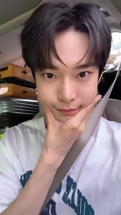 a young man sitting in the back seat of a car