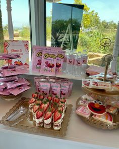 the dessert table is set up with pink treats