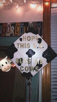 a decorated graduation cap that says, hope this is beyond me cow's head