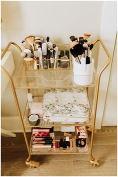 a gold trolley with makeup and cosmetics on it