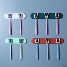 four toothbrushes are lined up in different colors and shapes, one is pink, the other is blue