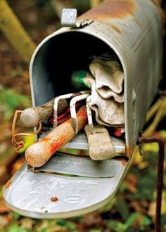 an old mailbox with various items in it