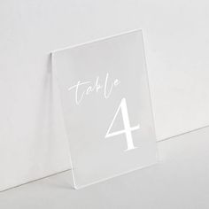 a clear acrylic table number with white numbers