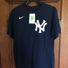 New With Tags Nike Navy Blue T-Shirt With Aaron Judge Number And Last Name. 100% Cotton. 19” From Underarm To Underarm. Mens Small. Bought At Yankee Stadium . Casual Navy Sports Shirt, Navy Casual Sports Shirt, Casual Navy Shirt For Sports, Navy Crew Neck Top With Team Logo, Navy Short Sleeve Fan Apparel Top, Navy Short Sleeve Fan Merchandise Top, Navy Short Sleeve Top For Fan Apparel, Casual Short Sleeve Shirt With Team Logo, Casual Cotton Shirt With Team Logo