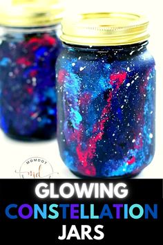 two jars filled with blue and red liquid sitting on top of a white table next to each other