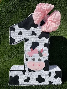 the number one is made out of paper and has a cow on it