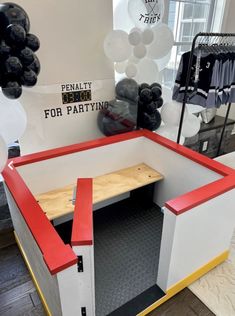 the inside of a clothing store with balloons in the background