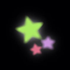 three stars glow brightly in the dark, with one glowing pink and one green star