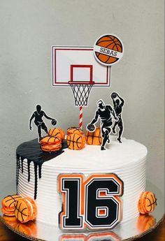 a birthday cake decorated with basketballs and the number 16 on top is white icing