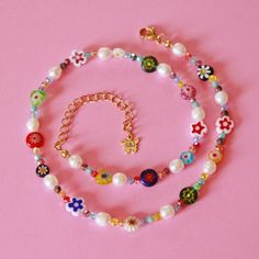 This stunning 18K Millefiori Beaded Necklace is a true work of art, handmade with love and featuring vibrant glass millefiori beads, glass pearls, and 5MM freshwater pearls. The elegant 18k gold plated stainless steel components add a touch of luxury to this piece, making it the perfect layering piece for any outfit.  measures 15'' with a 2'' extender handmade hypoallergenic  All necklaces, bracelets, body jewelry, and anklets are made out of 18k gold stainless steel chains and/or components. Al Luxury Colorful Beaded Glass Jewelry, Multicolor Pearl Jewelry With Heart Beads, Czech Glass Flower Jewelry With Colorful Beads, Flower Shaped Colorful Beads Jewelry Of Czech Glass, Multicolor Flower Spacer Beads Jewelry, Flower-shaped Jewelry With Colorful Czech Glass Beads, Flower-shaped Czech Glass Jewelry With Colorful Beads, Colorful Flower-shaped Czech Glass Jewelry, Cloth Butterfly