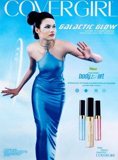 an advertisement for cosmetics featuring a woman in blue dress with her hands out to the side