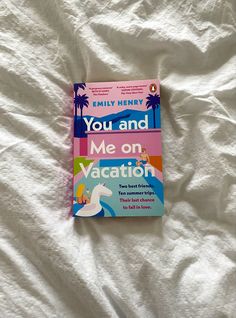 the book you and me on vacation is laying on a bed