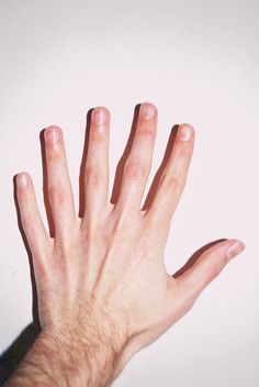 a person's hand reaching up towards the sky