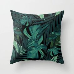 a pillow with green leaves on it