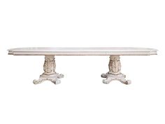 a white table with two pedestals on each end and an ornate design at the top