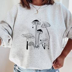 Mushroom Sweatshirt, Botanical Shirt, hippie shirt, Mushroom shirt, plant shirt, nature shirt, vintage plant shirt, botanical tee, Cute Mushroom Tshirt, Mushroom Tee, Nature Lover T-Shirt, Goblincore Shirt This soft and relaxed sweatshirt has a loose fit for a comfortable feel. Soft cotton and quality print T-shirts have-ribbed knit collars to bolster shaping cotton CARE Machine wash: warm (max 40C or 105F) Do not iron directly on the print ABOUT We are a small business of 1, I am a ceramic arti Casual Long Sleeve T-shirt With Plant Print, Relaxed Fit Fall Tops With Mushroom Print, Relaxed Fit Top With Mushroom Print For Fall, Relaxed Fit Mushroom Print Top For Fall, Cotton Fall Sweatshirt With Mushroom Print, Cotton Sweatshirt With Mushroom Print, Cotton Sweatshirt With Mushroom Print For Fall, Winter Cotton Tops With Mushroom Print, Casual Fall Sweatshirt With Mushroom Print