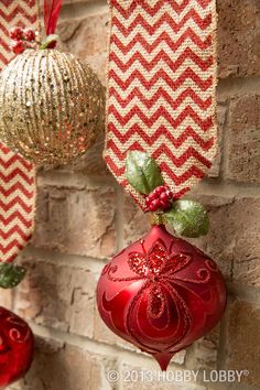 red and gold ornaments hanging on a brick wall