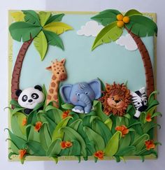 a cake with animals and giraffes in the jungle on it's side