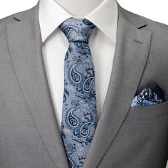 You'll enjoy hours of entertainment admiring the impressive detail of our Vader Blue Tonal Paisley Men's Tie. Carefully stitched in light blue, navy, and silver silks, our design features miniature Darth Vader helmets, Imperial and Rebellion icons, Stormtroopers, a flying Millennium Falcon, and so much more in a classic, yet nerdy paisley design. How many details can you find? Experience the Force and Dark Side with our expertly crafted 100% Silk tie. It's built to withstand the tests of galacti Luxury Blue Suit And Tie Accessories For Semi-formal Occasions, Blue Paisley Print Suit And Tie Accessories, Vader Helmet, Darth Vader Helmet, Light Blue Tie, Dark Vador, Silver Silk, Millennium Falcon, Men's Tie