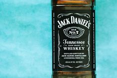 a bottle of jack daniels whiskey on a blue background