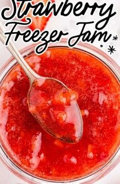 strawberry freezer jam in a glass bowl with a spoon on it and the title overlay reads, strawberry freezer jam