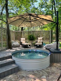 an outdoor hot tub in the middle of a patio