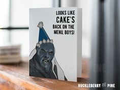 a card with an image of a man wearing a party hat on top of a table