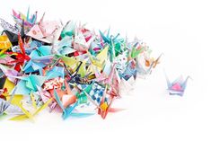 a group of origami birds sitting next to each other on a white surface