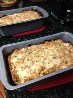 two pans filled with food sitting on top of a counter