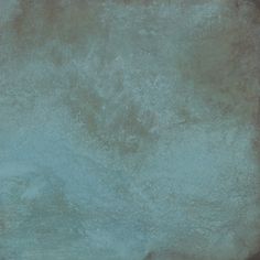 an image of a grungy wall textured with blue and green paint on it