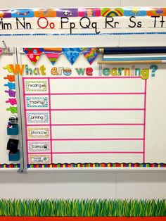 a bulletin board with writing on it in front of a whiteboard that says what are we learning?