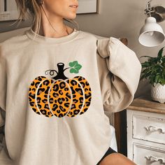 Crewneck Sweatshirt, Fall Sweatshirt, Pumpkin Crewneck Sweatshirt, Fall Pumpkin Shirt, Pumpkin Sweatshirt, Fall Time, Cheeta Print Pumpkin Introducing our latest must-have for the upcoming Fall season: the cozy and stylish Crewneck Sweatshirt. Embrace the crisp air and pumpkin spice vibes with our exquisite Fall Pumpkin Shirt. This Pumpkin Sweatshirt is the perfect embodiment of Fall Time charm, designed to keep you warm and fashionable as the leaves change. Crafted with the highest quality materials, this Fall Sweatshirt features a classic crewneck design that offers both comfort and a touch of elegance. The intricate Pumpkin design on the front captures the essence of autumn, making it a standout piece in your seasonal wardrobe. But that's not all - we've added a unique twist to this Fal Thankful Sweatshirt, Mickey Sweatshirt, Disney Sweatshirt, Leopard Pumpkin, Pumpkin Sweatshirt, Pumpkin Sweatshirts, Fall Time, Disney Sweatshirts, Thanksgiving Shirt