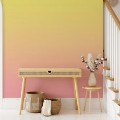 a pink and yellow wall in a room with two stools next to a table