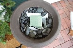 there is a soap and some rocks in the bowl