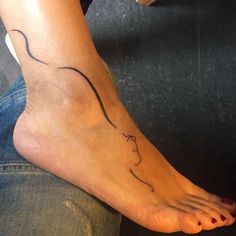 a woman's foot with a small tattoo on the side of her left leg