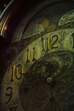 an old clock with roman numerals is shown in this close up photo,