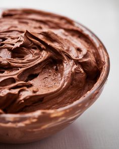 a bowl filled with chocolate frosting on top of a table