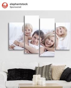 a living room with a couch and three pictures on the wall above it, in front of