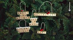 christmas ornaments made out of scrabbles hanging on a tree